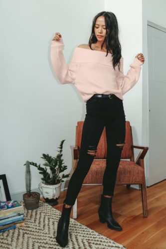 Cute outfit with lulus off the shoulder sweater in pink, ripped black skinny jeans, and black pointed-toe booties